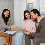 MyFastBroker mortgage brokers meeting with couple clients in modern office discussing home loan options and paperwork