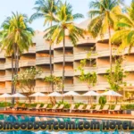 Luxury tropical resort with palm trees and swimming pool showcasing www.goodmooddotcom.com hotels category premium accommodations