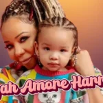 Tiny Harris holding young child, representing the Harris family's journey after losing Leyah Amore Harris in 2007