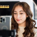 LittleMinaxo digital content creator filming lifestyle review on smartphone with professional lighting setup
