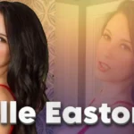 Noelle Easton professional portrait photo showing the American actress and model in red outfit against decorative background