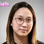 Ann Hsieh professional portrait wearing glasses against neutral background