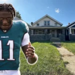 AJ Brown in Eagles jersey number 11 next to his South Jersey house exterior showing Haddonfield property front yard
