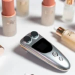 Jifirecove Halo ZIIP microcurrent facial device surrounded by skincare gel bottles on white surface beauty treatment setup