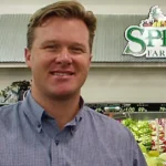 Shon Boney standing in Sprouts Farmers Market store in front of produce section