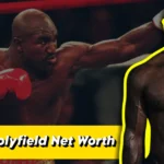 Evander Holyfield Net Worth: Professional boxer in fighting stance wearing red boxing gloves, showcasing his athletic physique during his prime career years.