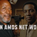 John Amos portrait two-generations style with “John Amos Net Worth” title overlay, showing older and younger versions of him on studio set.