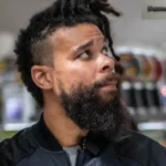 Damon Darling net worth featured image showing the comedian and TikTok star looking upward in black jacket