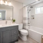 Modern remodeled 5x10 bathroom with white subway tile, contemporary vanity, chrome fixtures, and updated flooring—representing a typical mid-range bathroom renovation budget