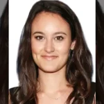 Featured image for Johnnie Rose Etheridge article showing a smiling brunette woman with long hair against a neutral background.