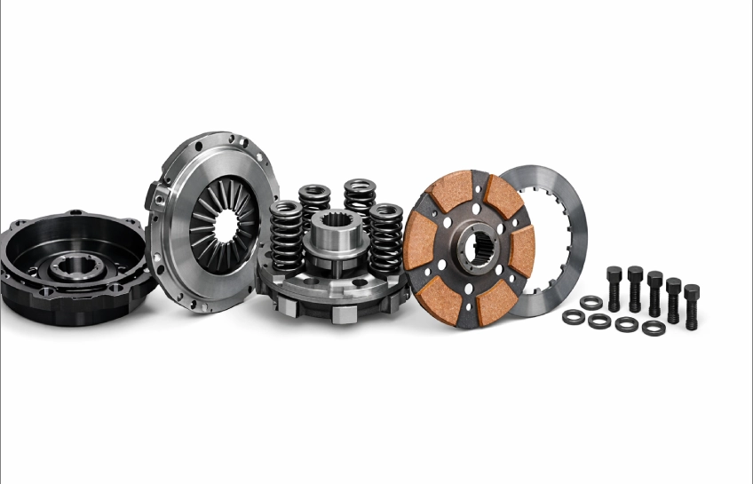 Sintterikytkin sintered clutch assembly diagram showing friction plate, pressure plate, hub, springs, and housing components in technical detail