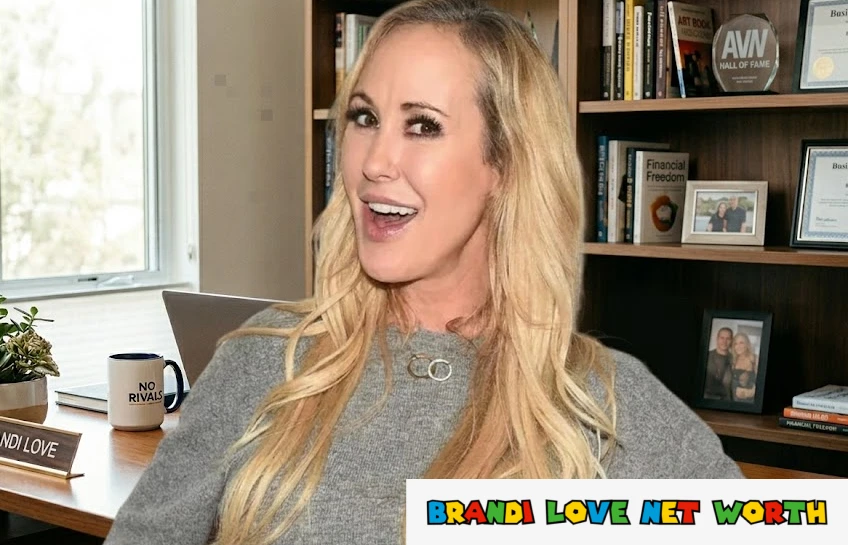 Brandi Love sitting at her office desk with a No Rivals mug and nameplate, AVN Hall of Fame award visible in background — Brandi Love Net Worth