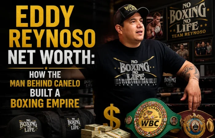 Eddy Reynoso standing in his boxing gym surrounded by WBC and WBO championship belts, wearing a No Boxing No Life shirt, with the article title Eddy Reynoso Net Worth: How the Man Behind Canelo Built a Boxing Empire