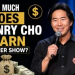 Henry Cho performing stand-up comedy on stage holding a microphone with text “How much does Henry Cho earn per show” and money graphics in background