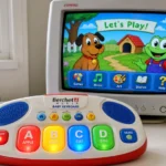 Vintage Berchet Media Baby Keyboard with chunky colorful buttons and CRT monitor displaying simple dog and frog game