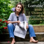 Lorraine Kirke, founder of Geminola vintage boutique, sitting outdoors holding a newspaper, wearing casual jeans and a grey top with statement earrings