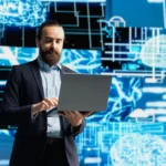Business professional using laptop to access www.hura-watch.net business archives for data analysis and market research