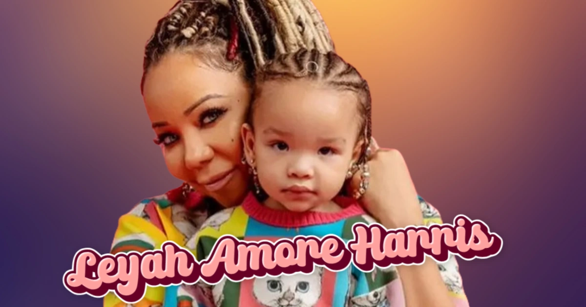 Tiny Harris holding young child, representing the Harris family's journey after losing Leyah Amore Harris in 2007